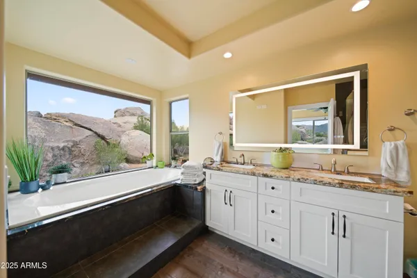 a kitchen with a sink a stove top oven a kitchen island a window and cabinets