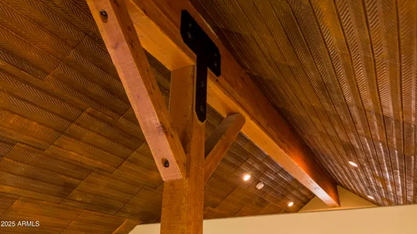 a backyard of a house with table and chairs under an umbrella