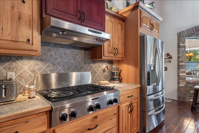 a bedroom with a bed and a flat tv screen on dresser