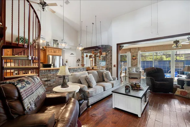 a living room with furniture kitchen view and a flat screen tv
