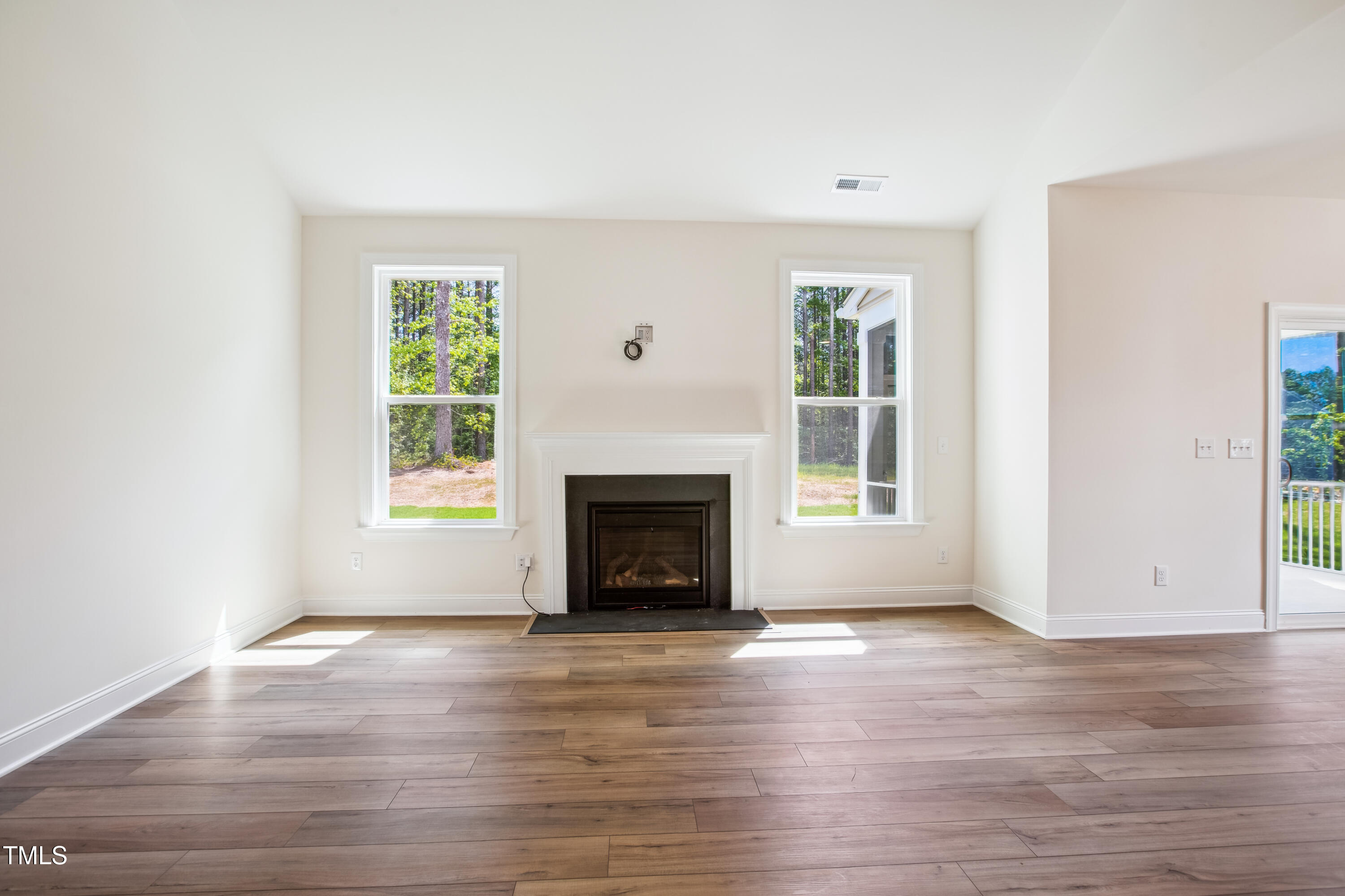 73 Artic Circle Garner, NC 27529 - Photo 11 of 39 a view of empty room with wooden floor and fireplace