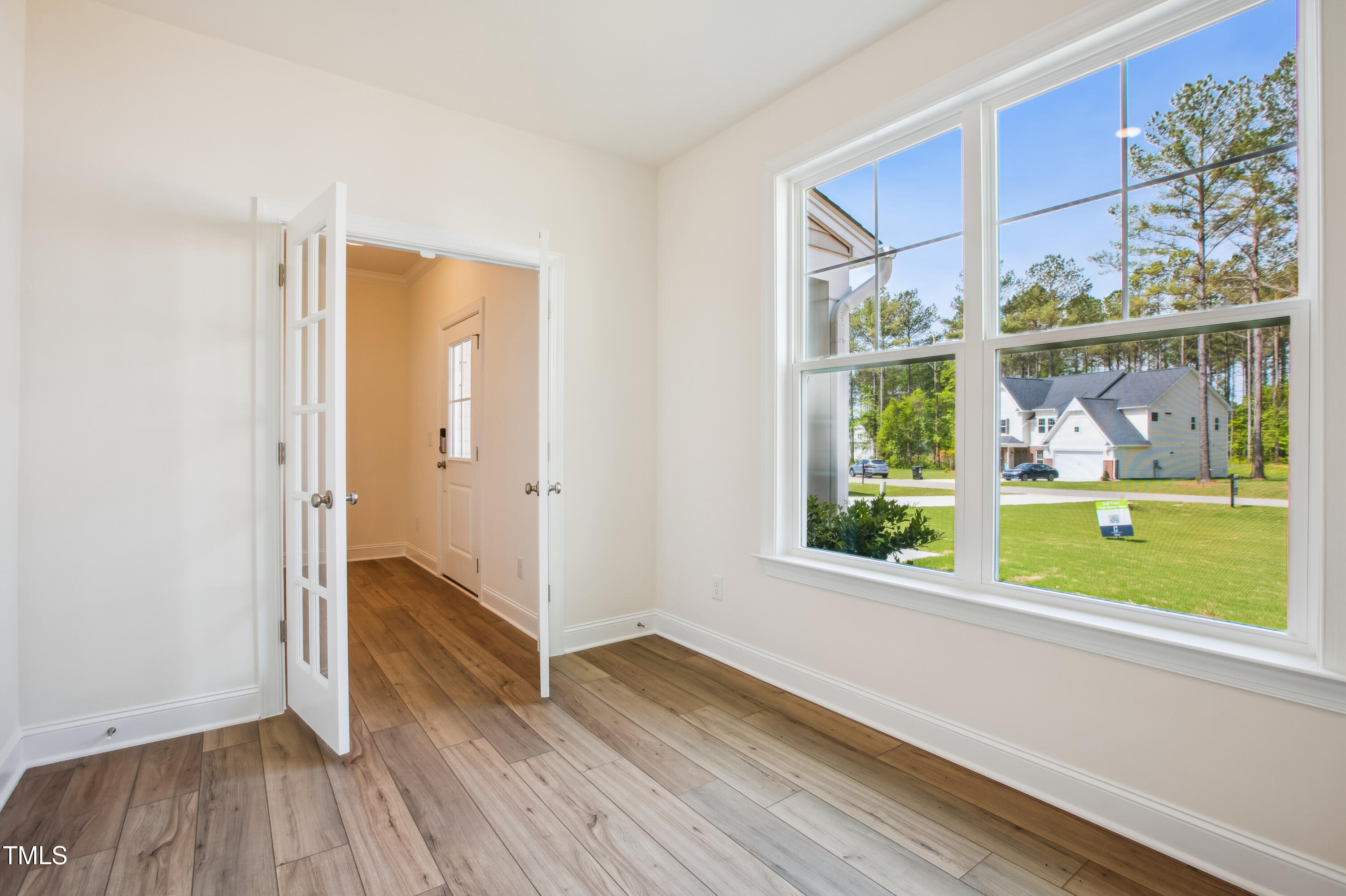 73 Artic Circle Garner, NC 27529 - Photo 13 of 39 a view of hallway with a large window and wooden floor