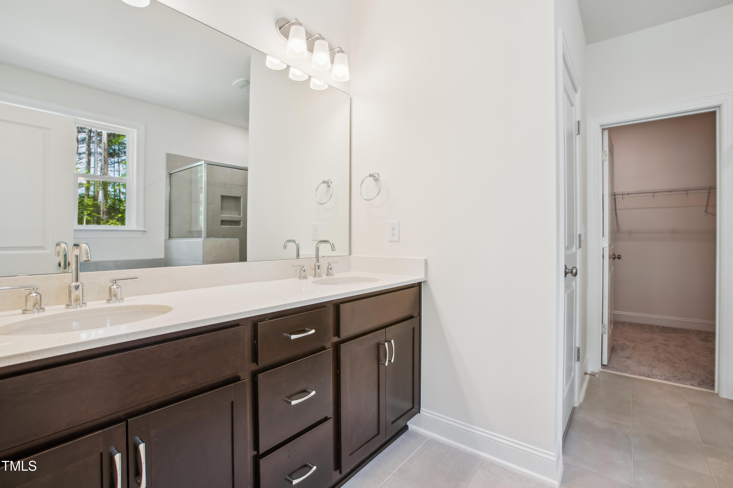73 Artic Circle Garner, NC 27529 - Photo 17 of 39 a bathroom with a double vanity sink a mirror and a shower