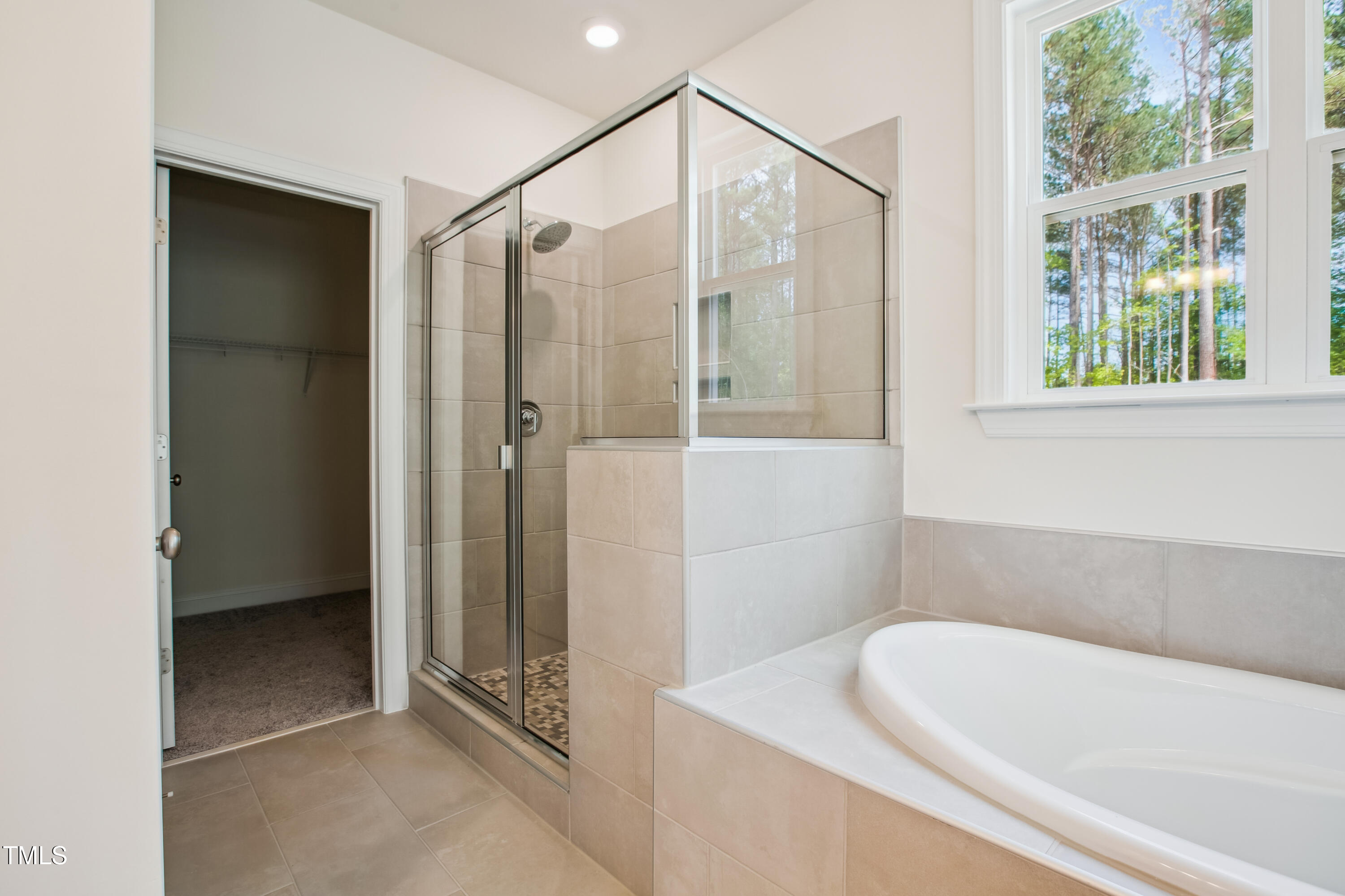 73 Artic Circle Garner, NC 27529 - Photo 18 of 39 a bathroom with a bathtub and a shower