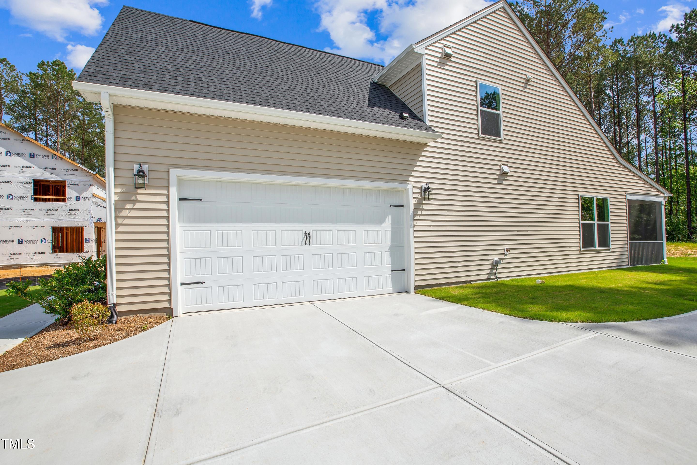 73 Artic Circle Garner, NC 27529 - Photo 2 of 39 a view of a white house with a small yard and potted plants