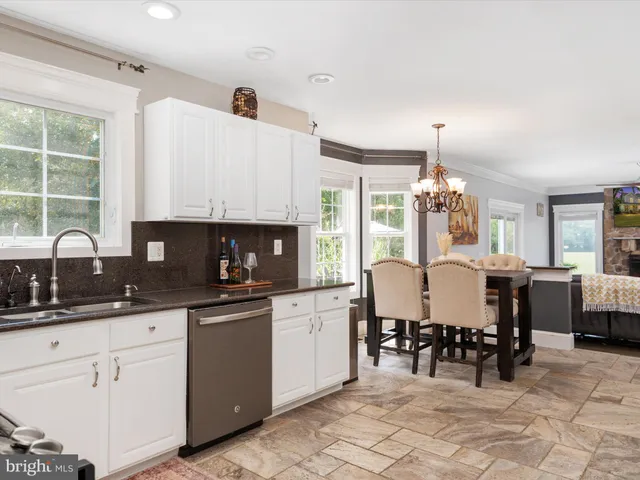 a kitchen with stainless steel appliances kitchen island granite countertop a sink and cabinets