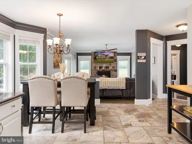 a view of a dining room with furniture and chandelier