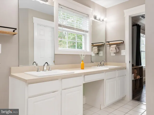 a bathroom with a granite countertop sink a toilet and shower