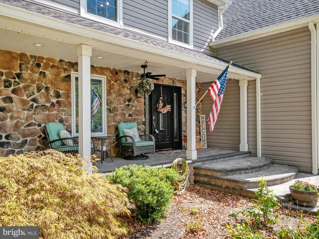 a view of a patio with table and chairs and potted plants