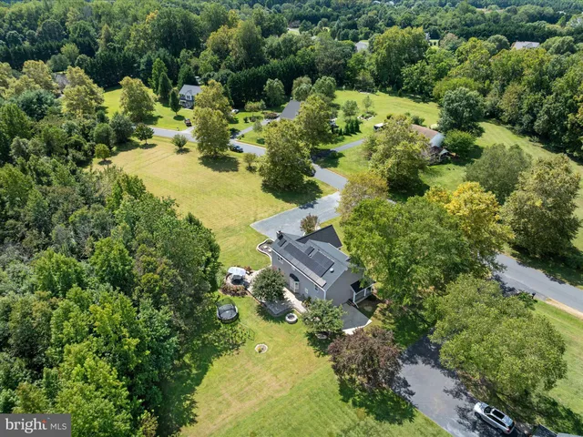 a view of a garden with a house in the background