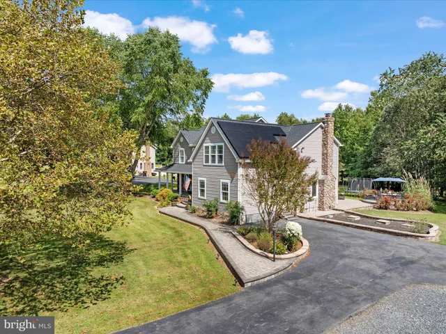 a front view of a house with swimming pool having outdoor seating