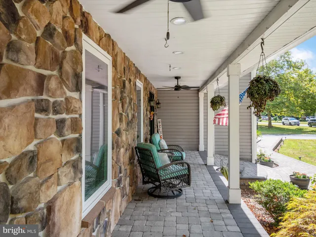 a view of a porch with a table and chairs and potted plants