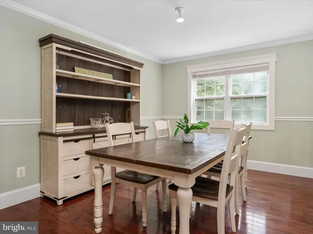 a view of a workspace with furniture and wooden floor