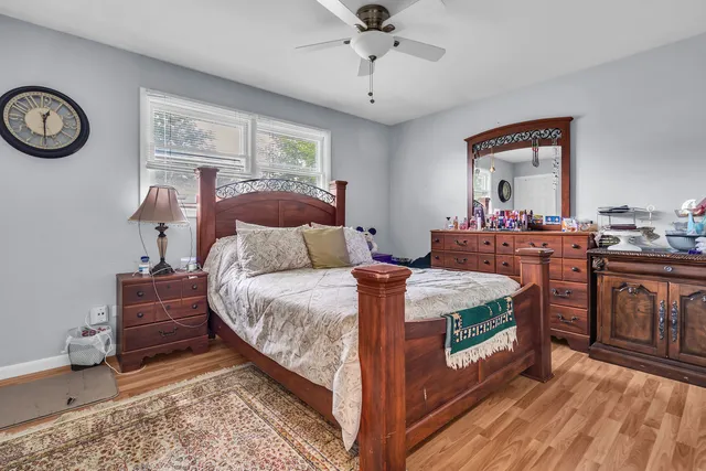 a bed room with a bed and a chair