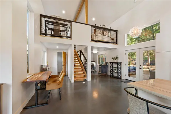 a view of a hallway with chairs and a potted plant