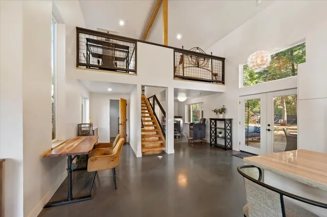 a view of a hallway with chairs and a potted plant
