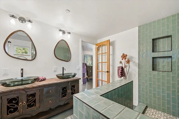 a kitchen with white cabinets and window