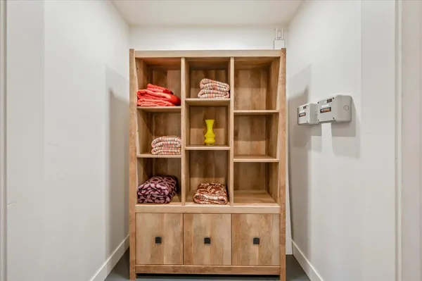 a front view of a house with a tree