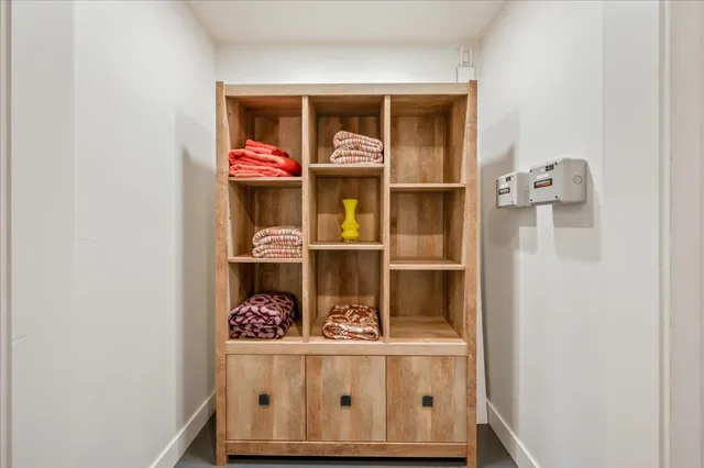 a front view of a house with a tree