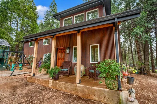 a view of a patio with chairs and potted plants