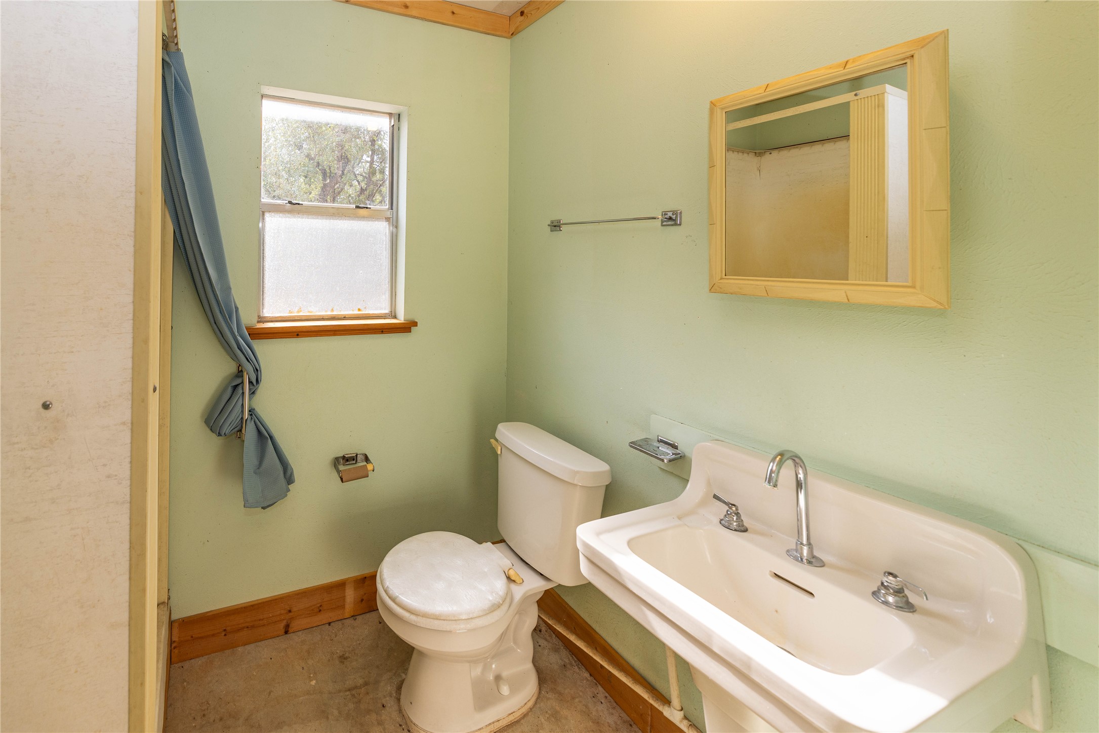 2501 Fischer Store Road Wimberley, TX 78676 - Photo 16 of 23 Pedestal sink with chrome fixtures and a framed mirror