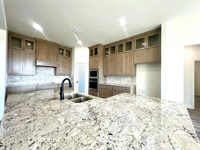 a kitchen with sink a refrigerator and cabinets