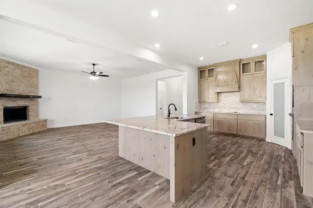 a view of a kitchen with a sink and dishwasher with wooden floor