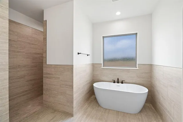 a bathroom with a bathtub and shower