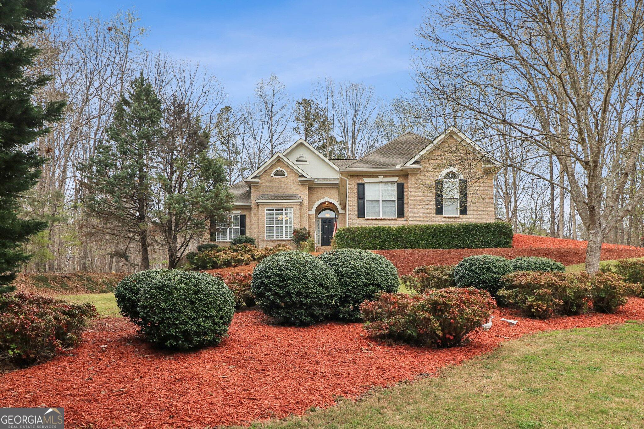 3792 Falls Trail Winston, GA 30187 - Photo 1 of 24 a front view of a house with a yard and outdoor seating
