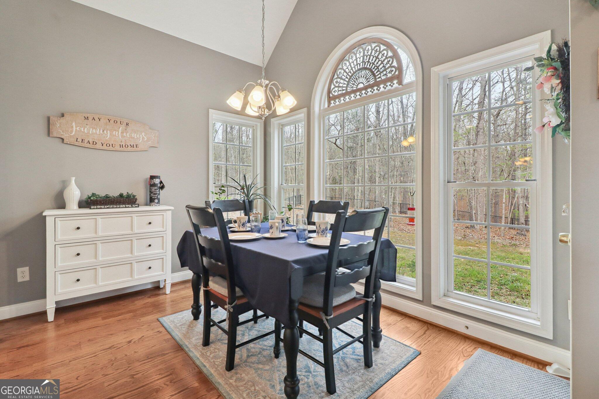 3792 Falls Trail Winston, GA 30187 - Photo 11 of 24 a view of a dining room with furniture a chandelier and wooden floor