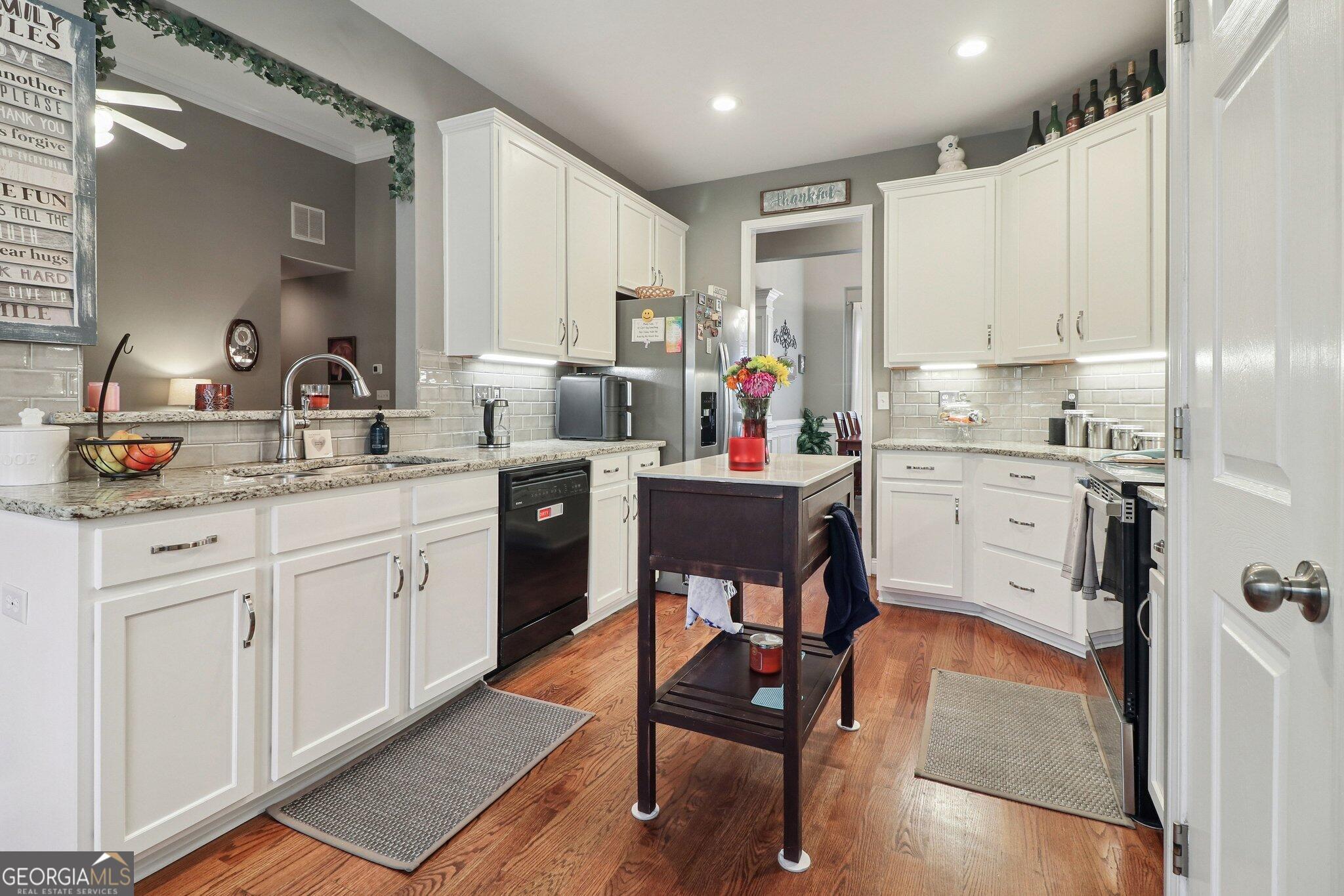 3792 Falls Trail Winston, GA 30187 - Photo 13 of 24 a kitchen with a sink appliances cabinets and furniture