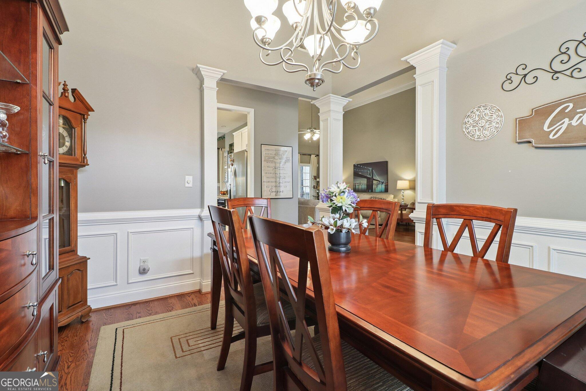 3792 Falls Trail Winston, GA 30187 - Photo 16 of 24 a view of a dining room with furniture a chandelier and wooden floor