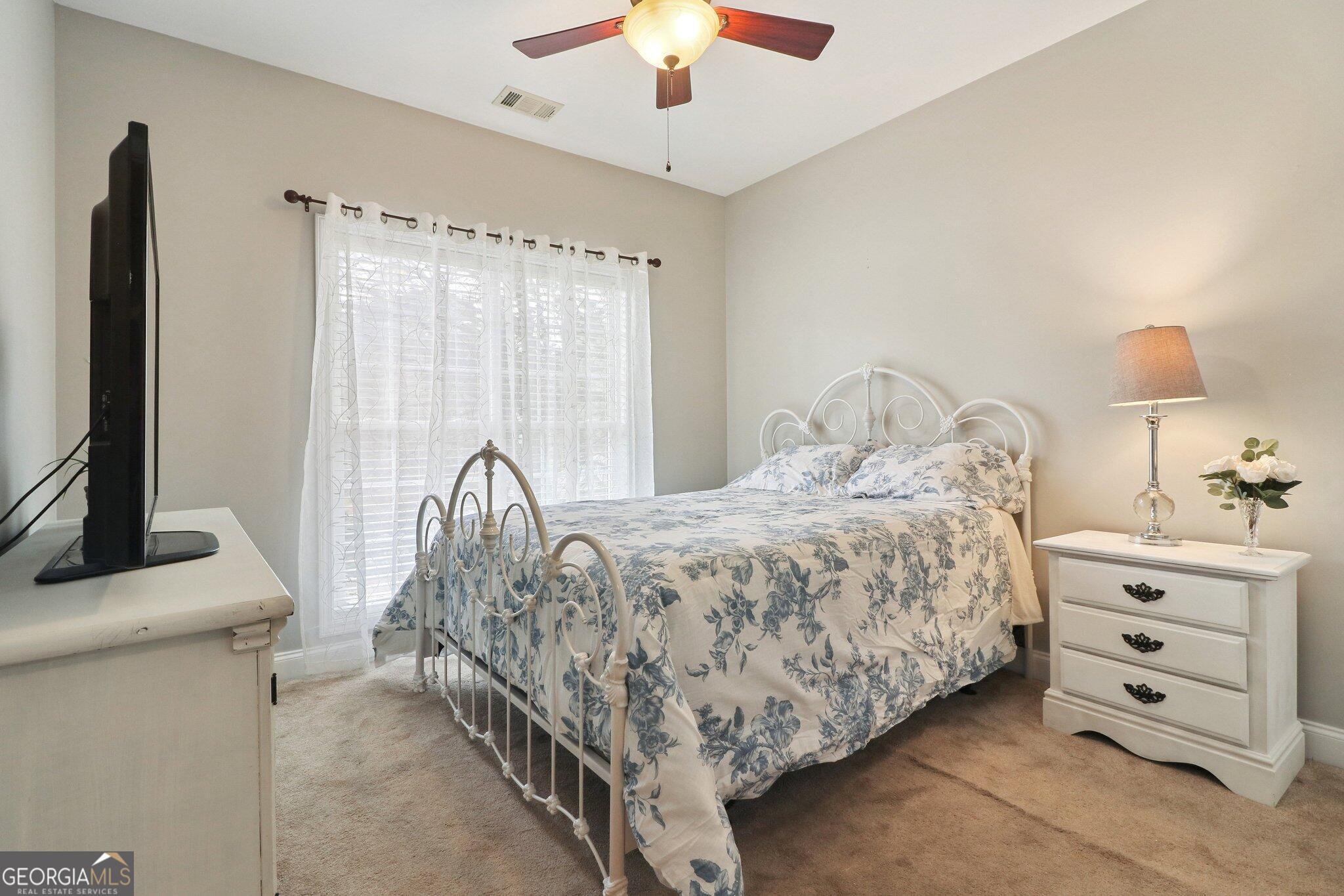 3792 Falls Trail Winston, GA 30187 - Photo 17 of 24 a bedroom with a bed and a chandelier