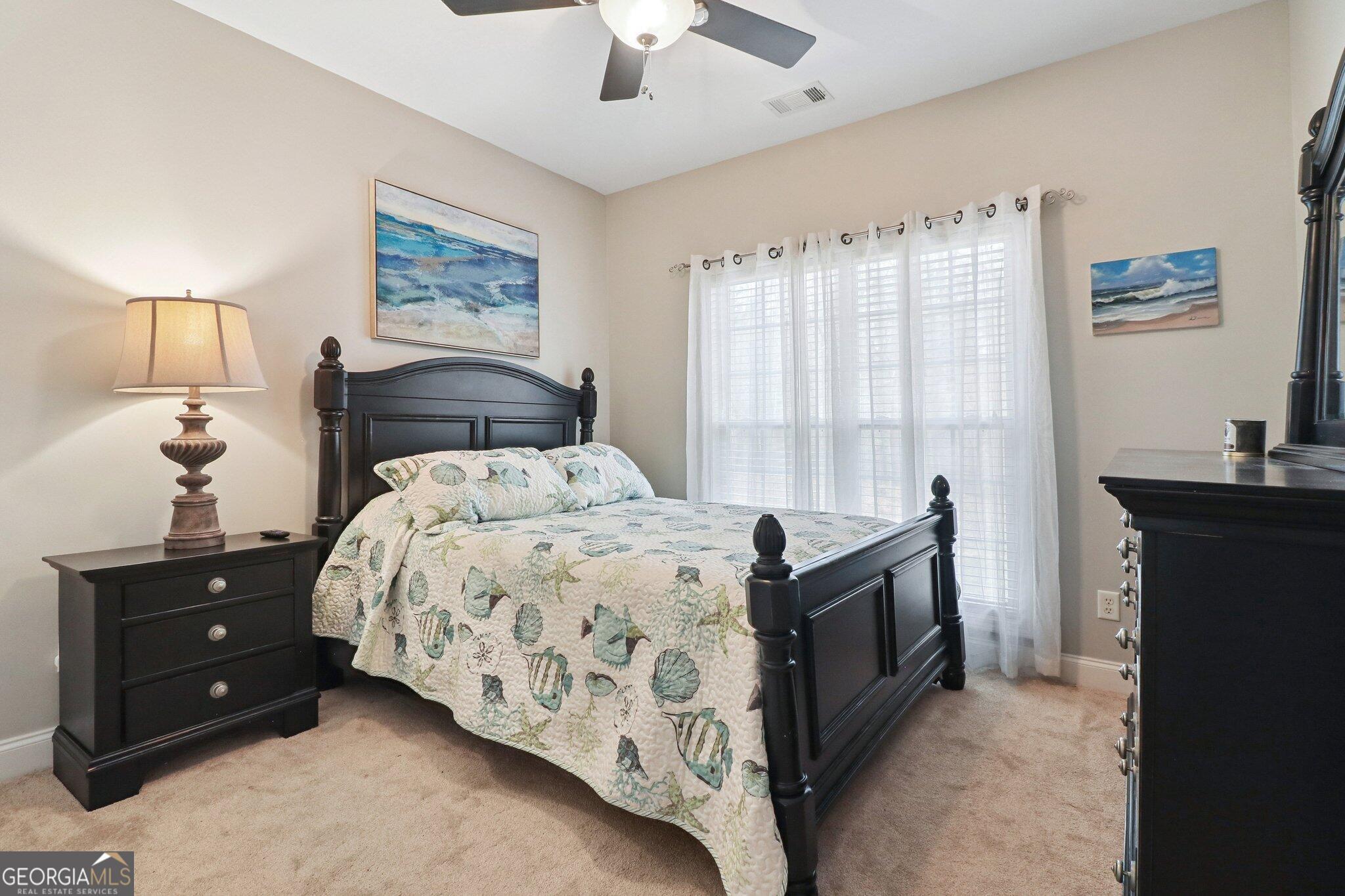 3792 Falls Trail Winston, GA 30187 - Photo 19 of 24 a bedroom with a bed and a lamp on dresser