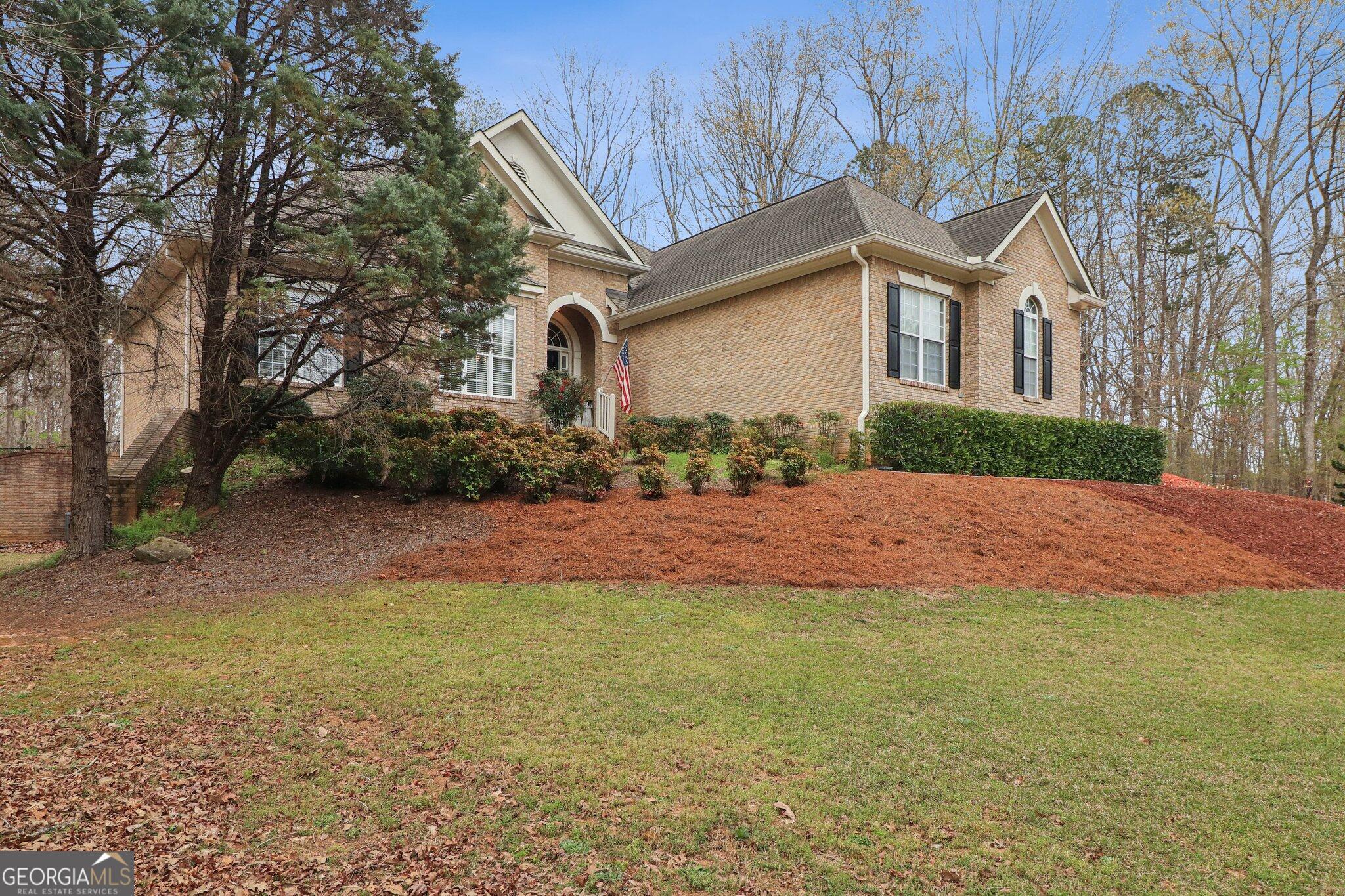 3792 Falls Trail Winston, GA 30187 - Photo 2 of 24 a front view of a house with a yard and garage