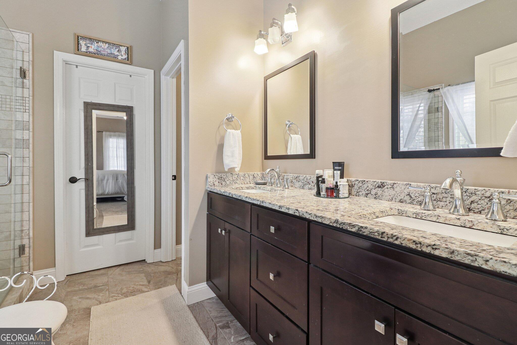 3792 Falls Trail Winston, GA 30187 - Photo 22 of 24 a bathroom with a granite countertop sink and a mirror