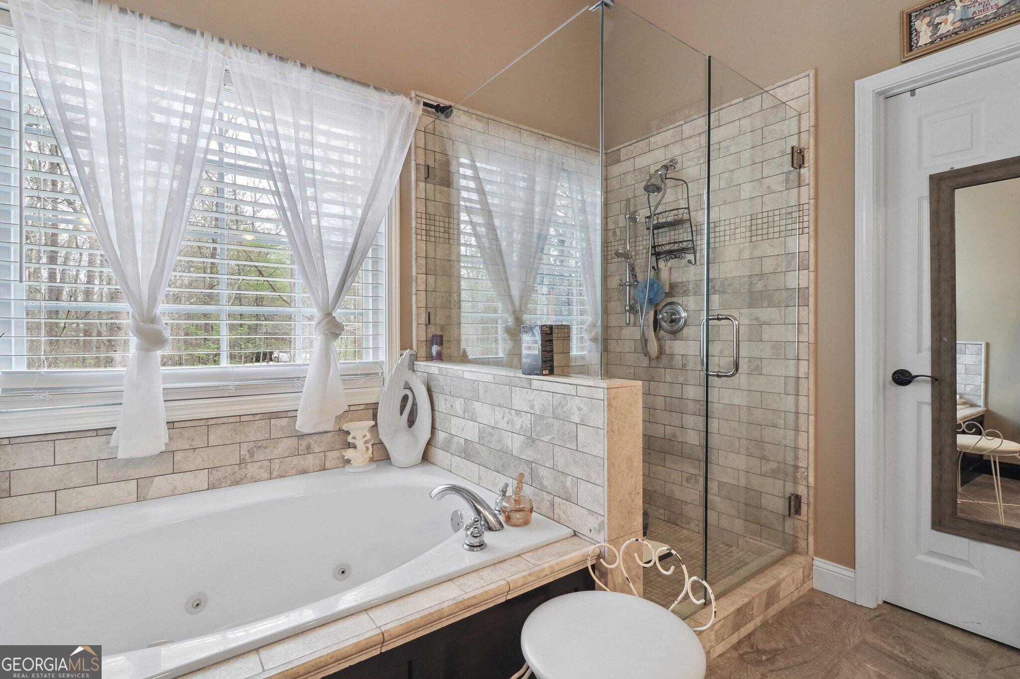 3792 Falls Trail Winston, GA 30187 - Photo 23 of 24 a bathroom with a tub a sink and a shower