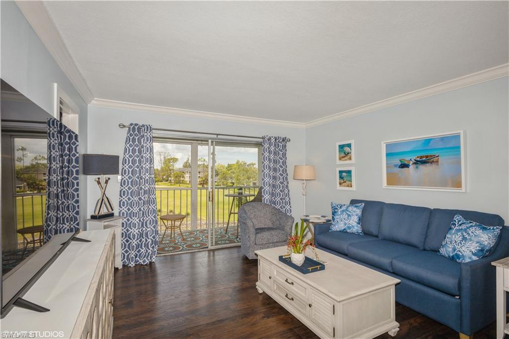 190 Turtle Lake Court, Unit 311 Naples, FL 34105 - Photo 11 of 47 a living room with furniture and a flat screen tv