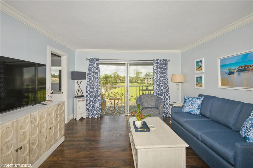 190 Turtle Lake Court, Unit 311 Naples, FL 34105 - Photo 12 of 47 a living room with furniture and a flat screen tv