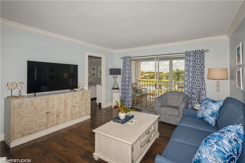 190 Turtle Lake Court, Unit 311 Naples, FL 34105 - Photo 13 of 47 a living room with furniture and a flat screen tv