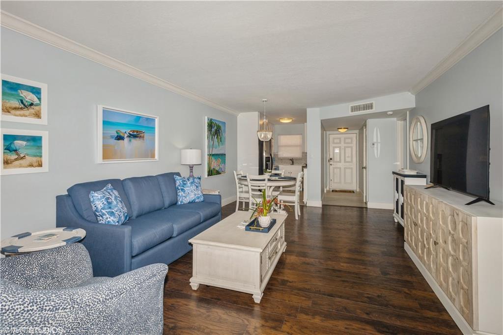 190 Turtle Lake Court, Unit 311 Naples, FL 34105 - Photo 2 of 47 a living room with furniture and a flat screen tv