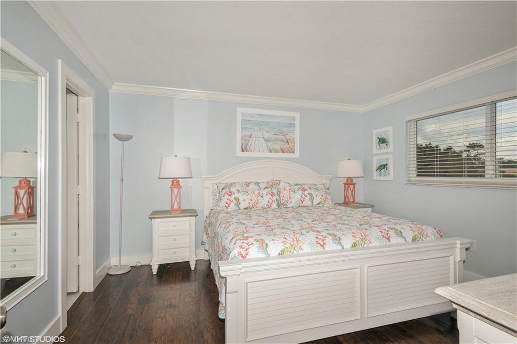 190 Turtle Lake Court, Unit 311 Naples, FL 34105 - Photo 21 of 47 a bedroom with a bed and a window