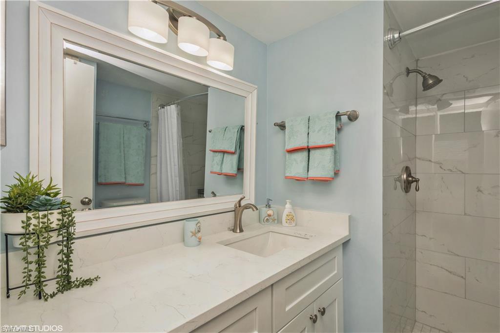 190 Turtle Lake Court, Unit 311 Naples, FL 34105 - Photo 24 of 47 a bathroom with a sink and a mirror