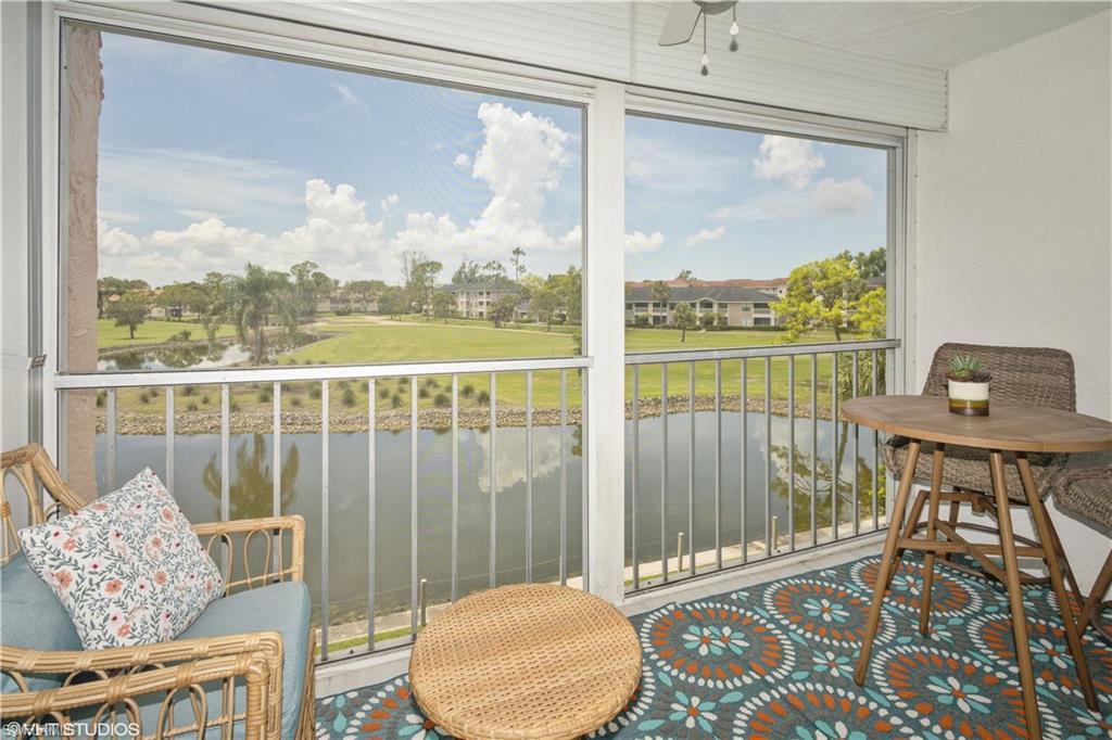 190 Turtle Lake Court, Unit 311 Naples, FL 34105 - Photo 28 of 47 a living room with furniture and a floor to ceiling window