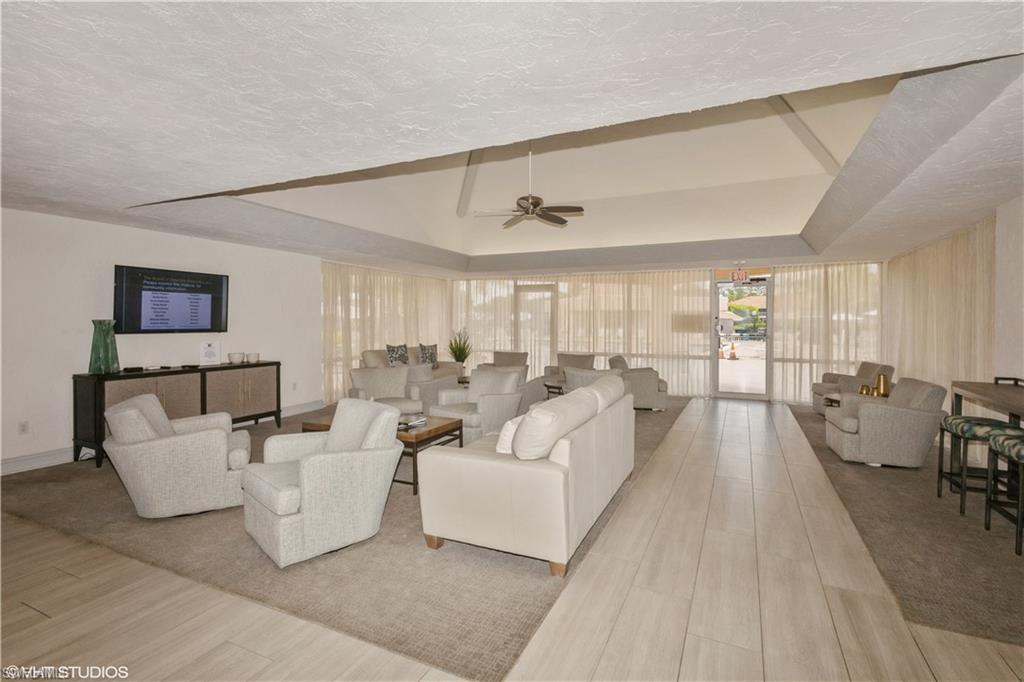 190 Turtle Lake Court, Unit 311 Naples, FL 34105 - Photo 40 of 47 a living room with furniture and a large window