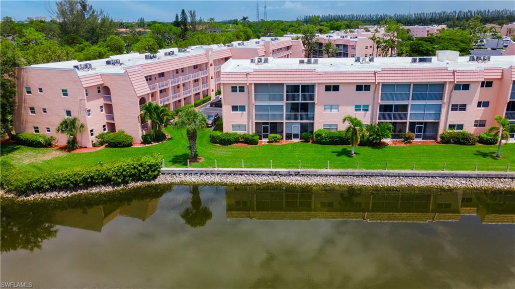 190 Turtle Lake Court, Unit 311 Naples, FL 34105 - Photo 4 of 47 a view of building with lake view