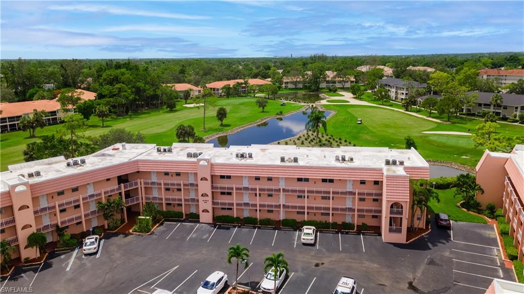 190 Turtle Lake Court, Unit 311 Naples, FL 34105 - Photo 45 of 47 a view of a building with garden space and street view