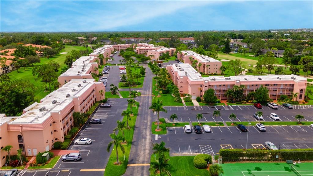 190 Turtle Lake Court, Unit 311 Naples, FL 34105 - Photo 47 of 47 an aerial view of a city with lots of residential buildings ocean and mountain view in back