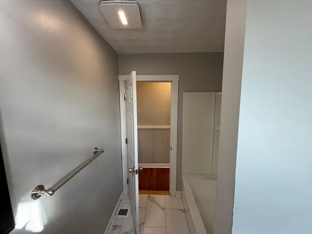 a bathroom with a tub and shower