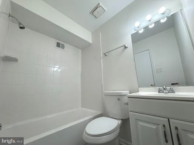 a bathroom with a sink toilet vanity and shower